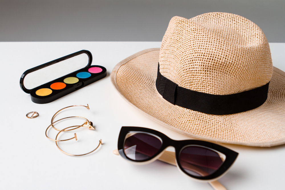 decorative-cosmetics-accessories-sunglasses-hat-white-table